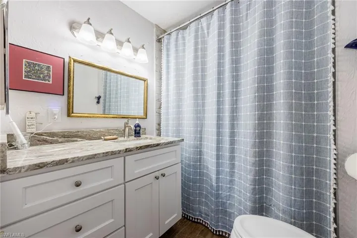 Primary Bath with granite and tile walk in shower