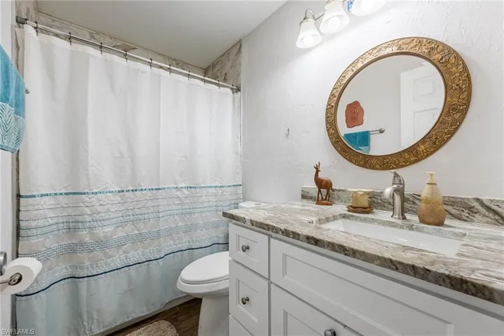 Guest bath with granite, white shaker vanity