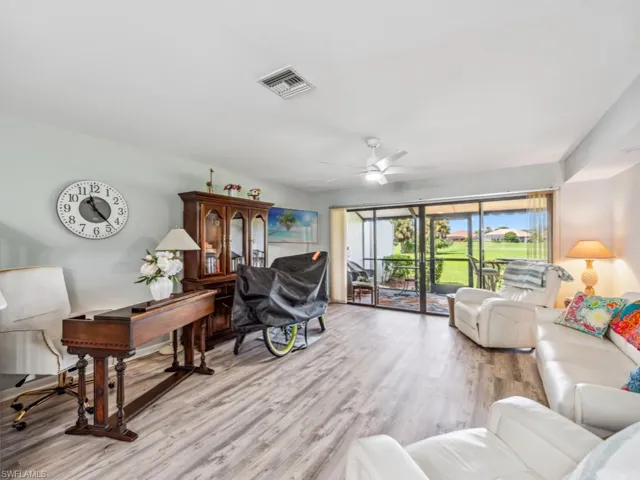 Living room featuring ceiling fan and light hardwood / wood-style flooring