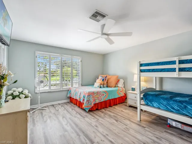 Bedroom featuring ceiling fan and hardwood / wood-style flooring