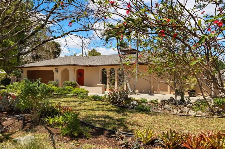 Ranch-style home featuring a garage and stucco siding