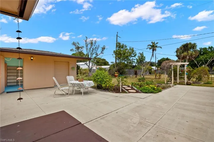 View of patio with outdoor dining area and fence