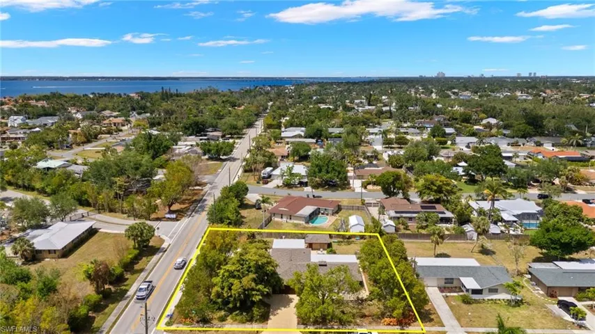 Birds eye view of property featuring a residential view and a water view