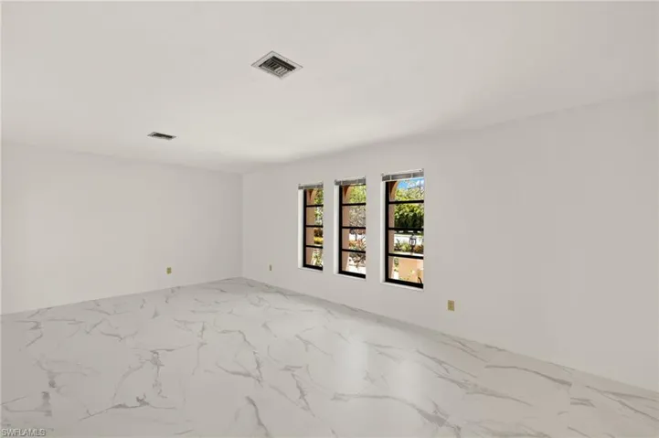 Living Room with marble-like tile finish floor and visible vents