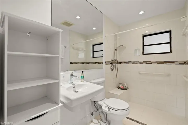 Full bath featuring recessed lighting, a tile shower, visible vents, and toilet