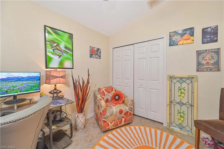Compact room featuring neutral-toned walls and tile flooring