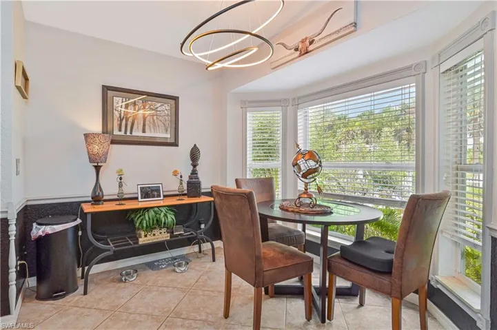 Bay window with white blinds and decorative casing