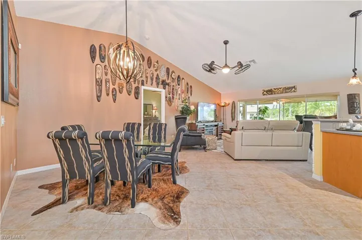 Spacious open-concept interior featuring vaulted ceilings and tile flooring