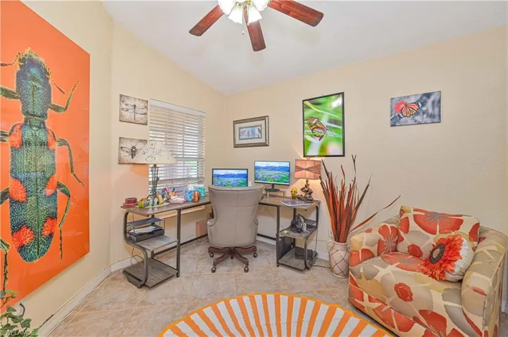 Versatile room featuring tile flooring, a window with horizontal blinds, and a ceiling fan with integrated lighting