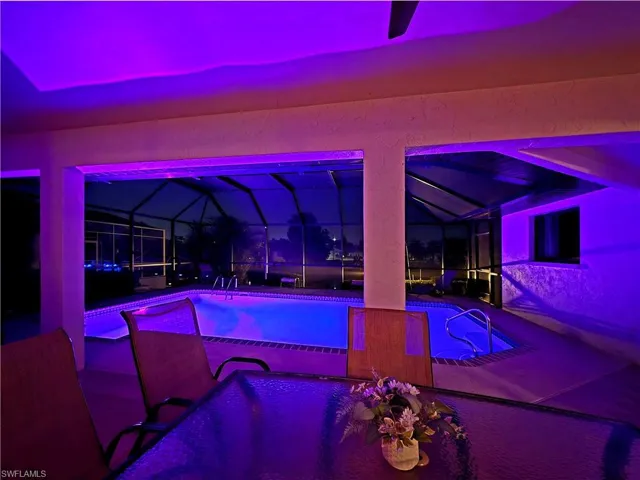 Covered lanai featuring a private screened-in pool and spa with integrated lighting