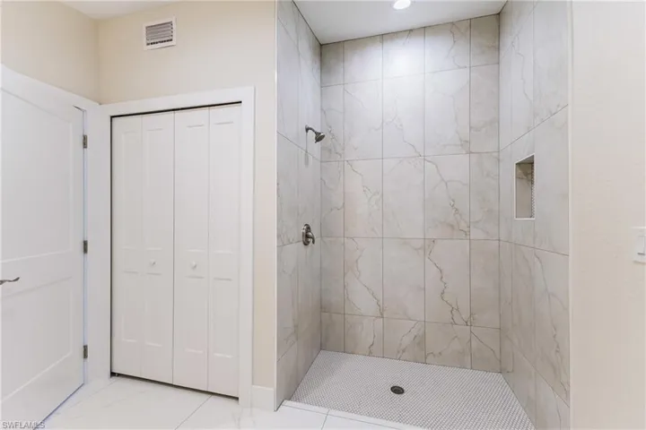Full bathroom featuring a closet and a stall shower