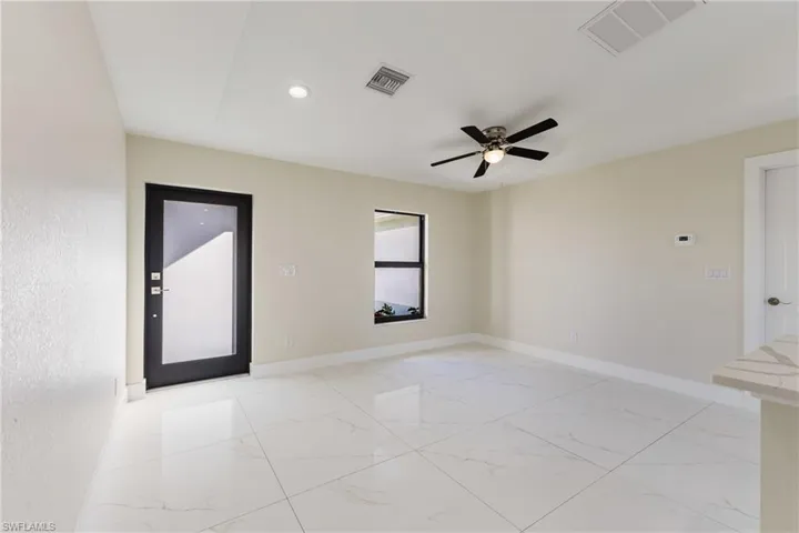 Spare room with light marble finish floors, ceiling fan, and recessed lighting