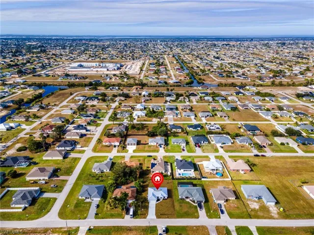 Aerial view of property's location featuring nearby suburban area and a nearby body of water