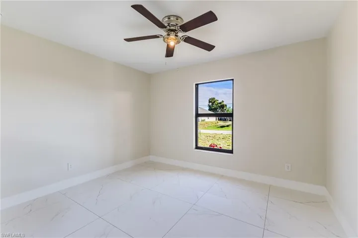 Unfurnished room with baseboards and light marble finish floors