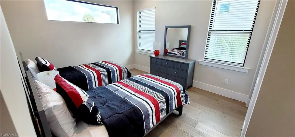 Bedroom featuring baseboards and light wood finished floors