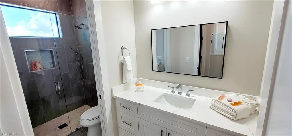 Bathroom featuring vanity, a shower stall, and tile patterned flooring