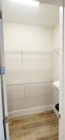 Walk in closet featuring light wood-type flooring