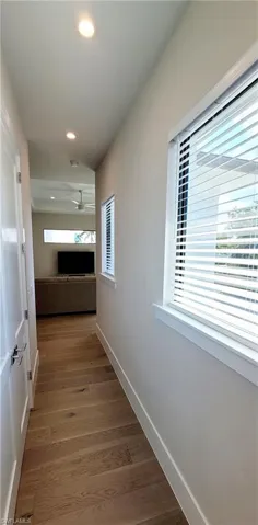 Hall with recessed lighting and light wood-style floors