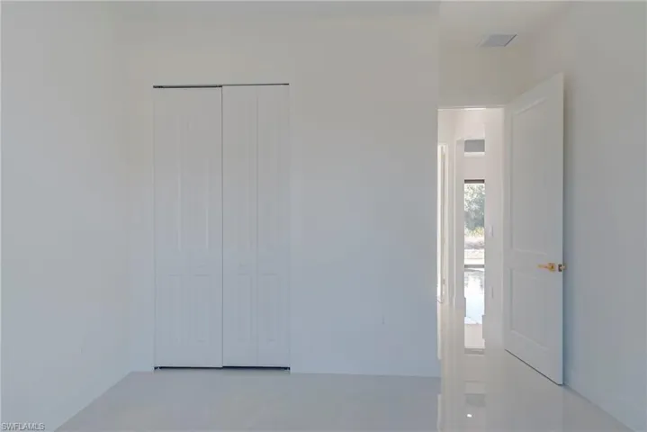 Unfurnished bedroom featuring a closet and baseboards