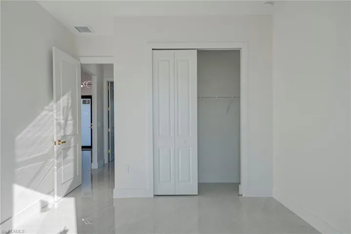 Unfurnished bedroom with baseboards and a closet