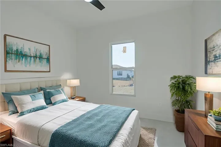 Bedroom featuring ceiling fan and baseboards