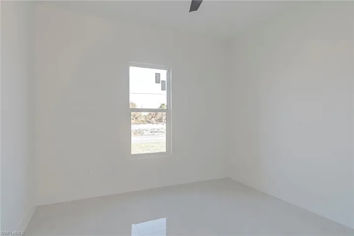 Unfurnished room featuring baseboards and a ceiling fan