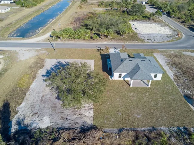 Aerial view of property and surrounding area with a nearby body of water