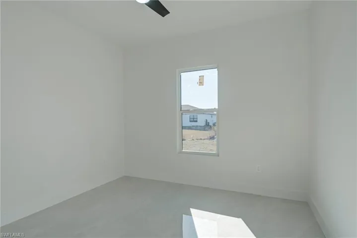 Spare room with baseboards and ceiling fan