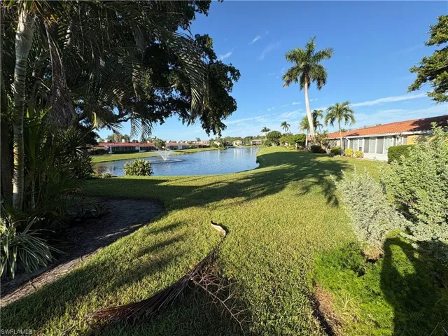 View of grassy yard with a water view