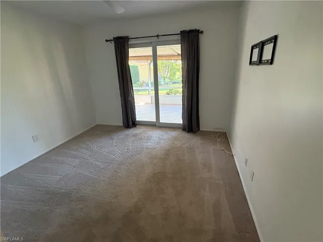 Carpeted empty room featuring baseboards