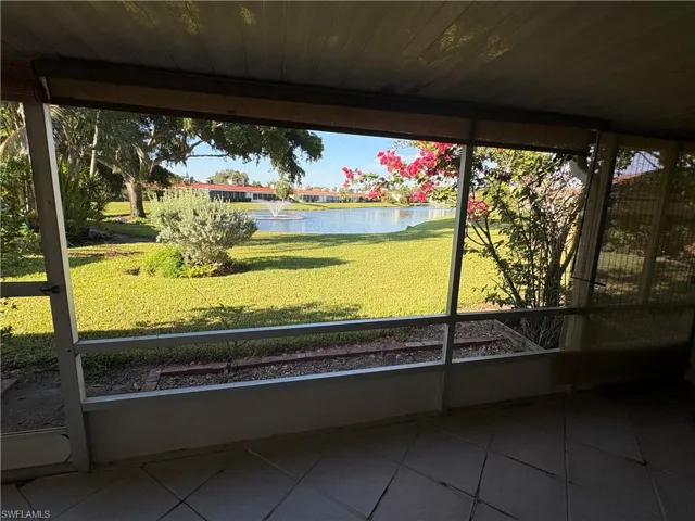 Unfurnished sunroom featuring a water view
