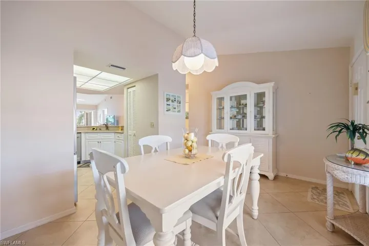 Dining space with light tile patterned floors