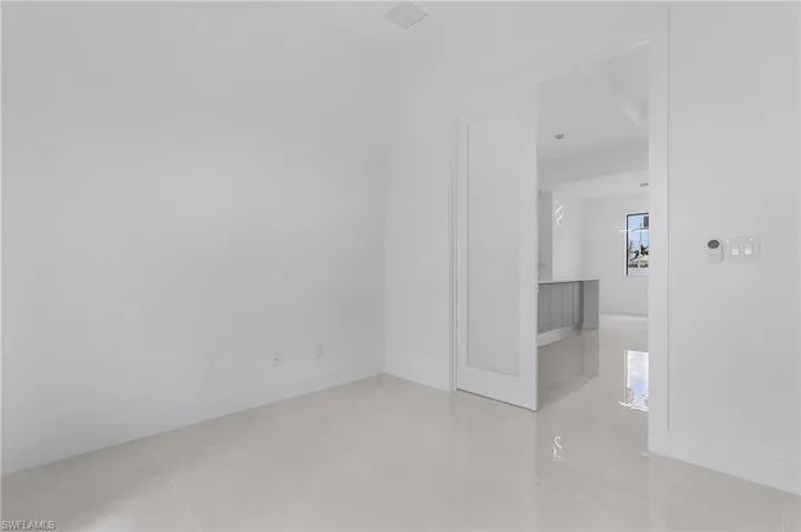 Unfurnished room featuring light tile patterned floors