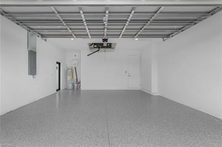 Garage with water heater and electric panel