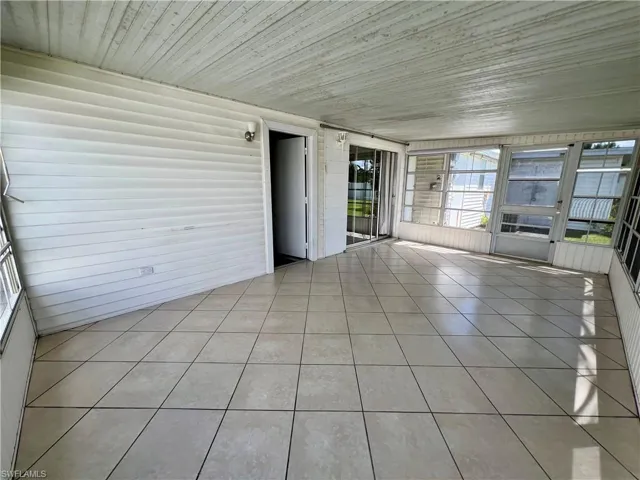 Unfurnished sunroom with wood ceiling