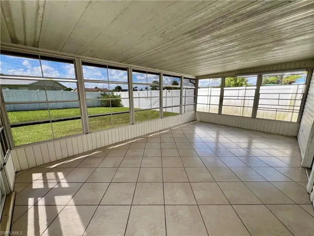 Unfurnished sunroom with lofted ceiling and wooden ceiling
