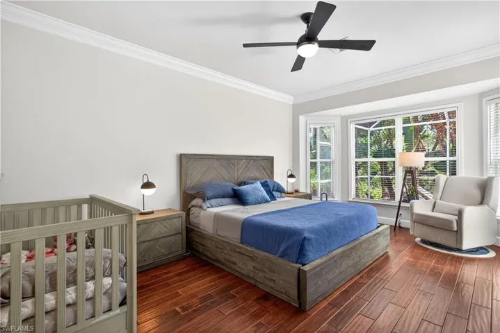 Primary bedroom suite with beautiful wood plank flooring and beautiful sunshine