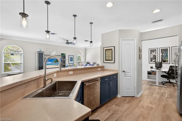 Kitchen with oversized stainless steel sink and food pantry