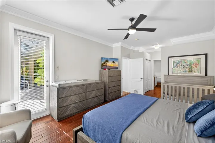 Spacious primary bedroom with glass door leading to private pool area