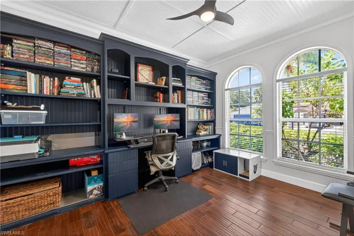 Spacious, sunfilled office with wood plank flooring, palladium windows, ceiling fan and decorative ceiling