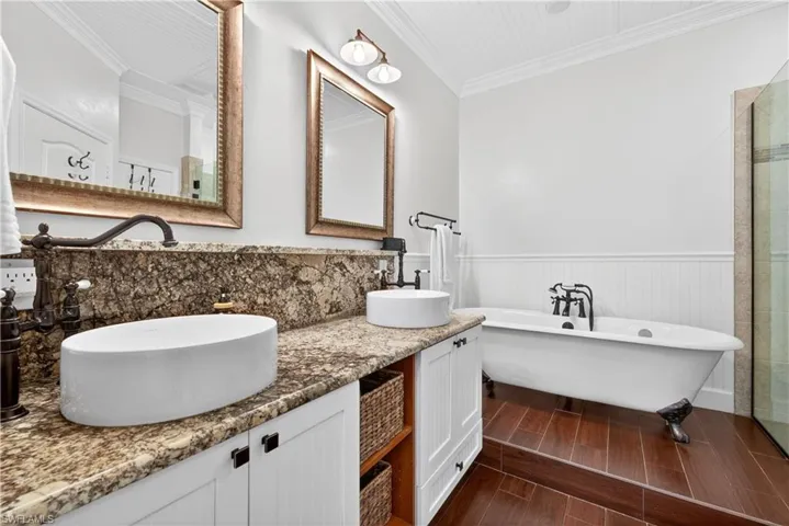 Luxurious, primary bath with duel sinks and clawfoot soaking tub....just unwind, relax and wash the day away