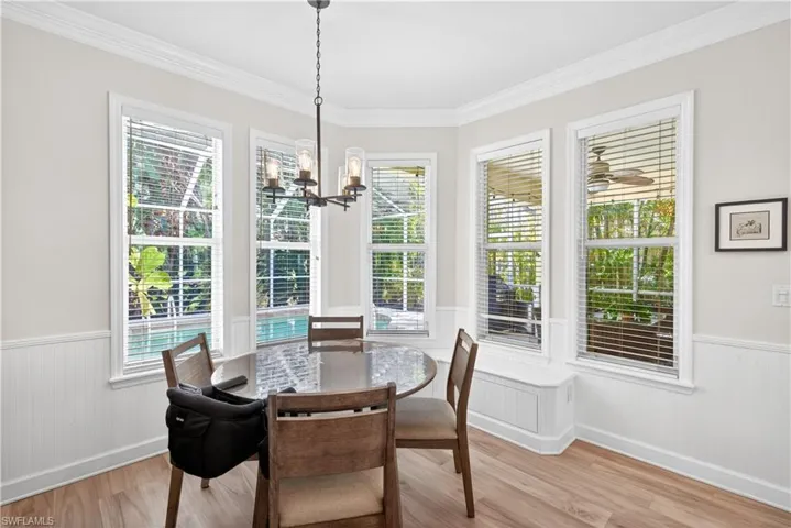 Lovely, sun-soaked dining area flanked with large windows and built in window seat