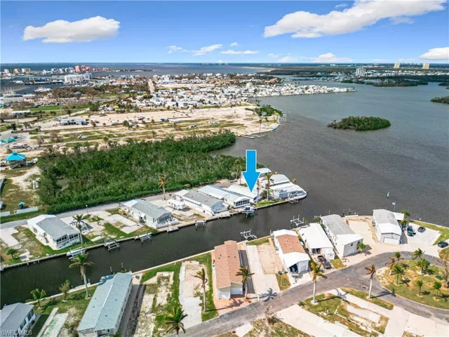 Birds eye view of property with a water view