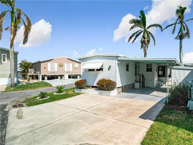 View of front of property with a carport