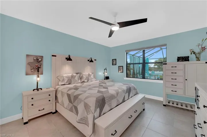 Bedroom with light tile patterned floors and a ceiling fan