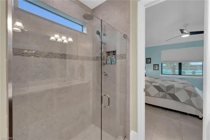 Bathroom with ensuite bath, a stall shower, and tile patterned flooring