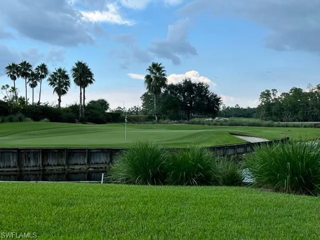 View of home's community featuring golf course view and a putting area