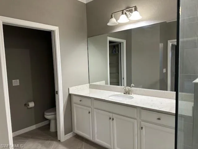 Master Bathroom featuring tile patterned flooring, vanity, and toilet