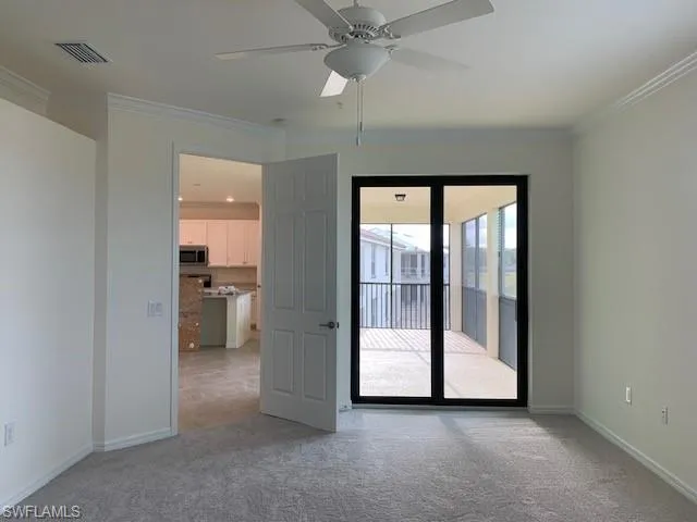 Master bedroom with crown molding and ceiling fan