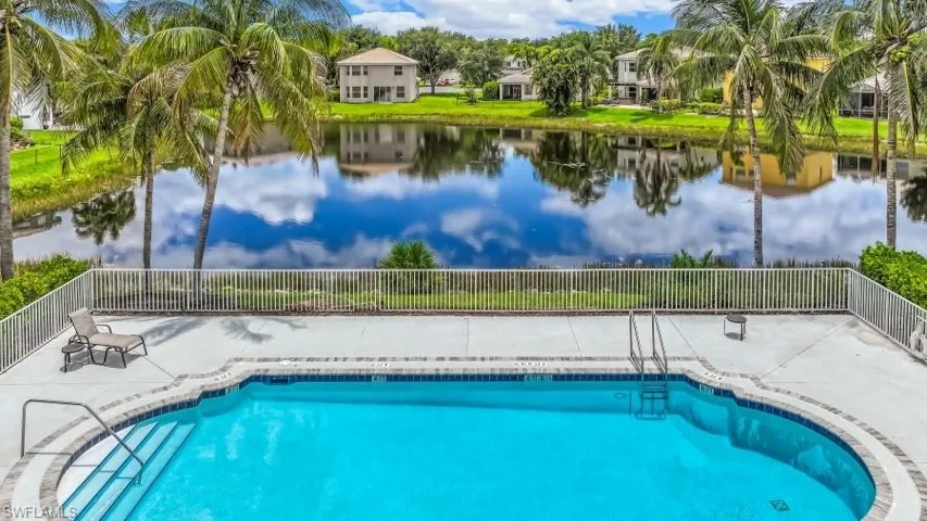Outdoor swimming pool with integrated steps, surrounded by a concrete patio